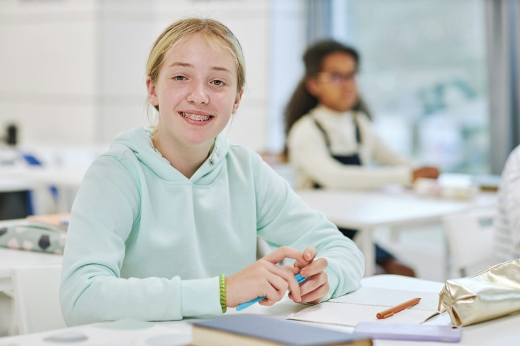 Teen Girl with Braces in School